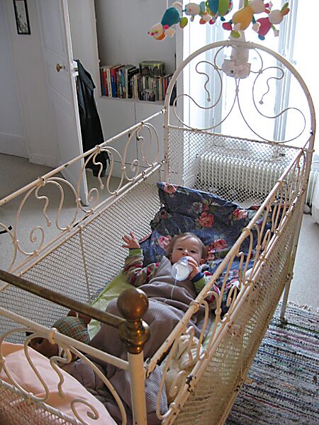 After a long afternoon of site-seeing, Erika takes a rest in her Parisian-style bed. Martine has the house set up for grandchildren, with lots of toys and accomodations for small ones.